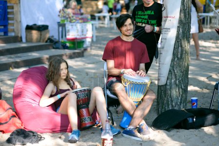 Foto de Gente sentada en sillas colocadas sobre arena, tocando tambores de copa y cantando. Fest Vedalife. 25 de julio de 2018. Kiev, Ucrania - Imagen libre de derechos