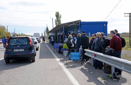 Photo for Travelers standing in line for passport control procedure at the border crossing point Kalanchak. September 20, 2017. Kalanchak region, Khersonskaya oblast, Ukraine - Royalty Free Image