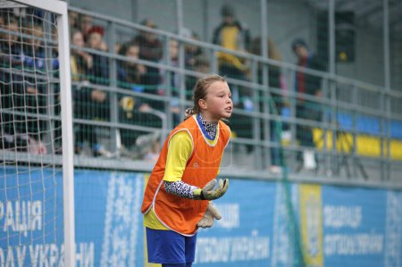 Photo for Girl goalkeeper doing her work in front of a football goal. Football Girls Ukraine Cup EmPower Girl , final game moments. October 11, 2017. Kiev, Ukraine - Royalty Free Image