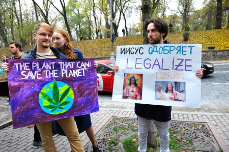 Photo for Group of young people activists standing near Cabinet of Ministry holding broadsheet demanding legalization of medical marijuana. Cannabis March. October 26, 2019. Kyiv, Ukraine - Royalty Free Image