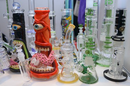 Made of glass bongs for cannabis smoking placed on the counter of the shop