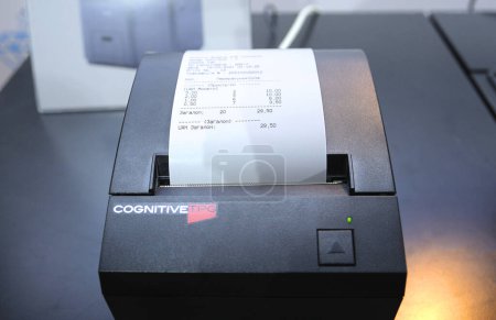 Photo for Receipt printer of the cash recycler working. Exhibition Retail Industry-2021. March 16, 2021. Berezovka, Ukraine - Royalty Free Image
