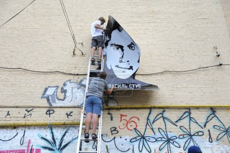 Téléchargez les photos : Sur le mur du bâtiment, de jeunes militants ont peint le portrait-affiche du célèbre poète et dissident ukrainien Vasyl Stus. 12 juin 2018. Kiev, Ukraine - en image libre de droit