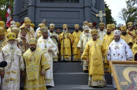 Photo for Orthodox priests in golden cassocks standing bored during prayer. Cross procession. July 28, 2019. Kyiv, Ukraine - Royalty Free Image