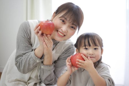 Photo for Parent and child with apples - Royalty Free Image