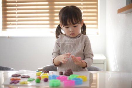 Photo for Girl playing with clay - Royalty Free Image