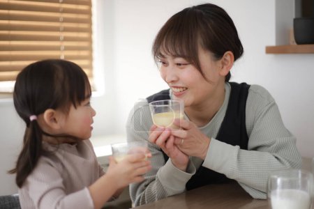 Photo for Parent and child eating homemade pudding - Royalty Free Image