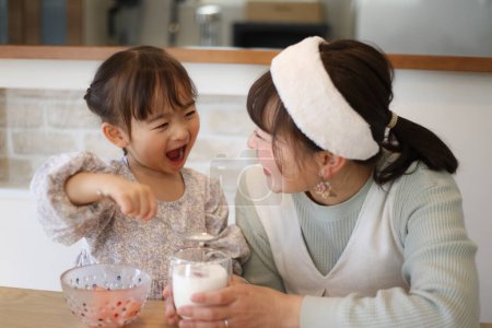 Photo for Parent and child making strawberry milk - Royalty Free Image