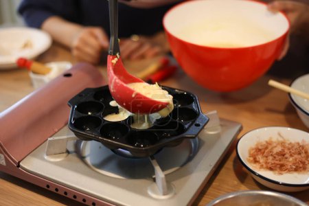 Photo for A woman making takoyaki - Royalty Free Image
