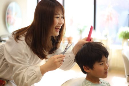 Photo for Smiling hairdresser and boy - Royalty Free Image