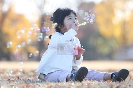 girl playing with soap bubbles