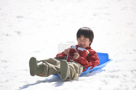 Photo for Boy playing on a sled - Royalty Free Image