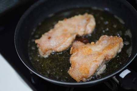 Photo for How to fry chicken thighs in oil - Royalty Free Image