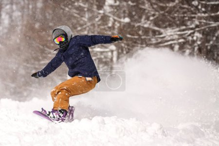 Image of a man snowboarding