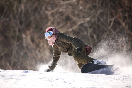 Image of a woman snowboarding