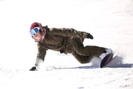 Image of a woman snowboarding