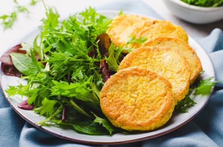 Photo for Tofu Fritters, Vegetarian Food, Vegan Soy Bean Pancakes, Savory Appetizer with fresh salad on a plate on bright background - Royalty Free Image