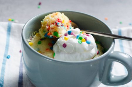 Photo for Funfetti Mug Cake, Homemade Cake Cooked in the Microwave on Bright Background - Royalty Free Image