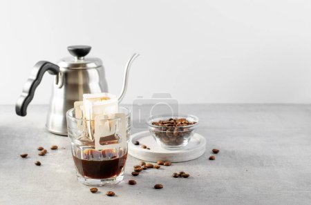 Photo for Drip Coffee Bag in a Cup, The Process of Brewing Coffee, Quick Way to Brew Ground Coffee Using Paper Type Filter - Royalty Free Image