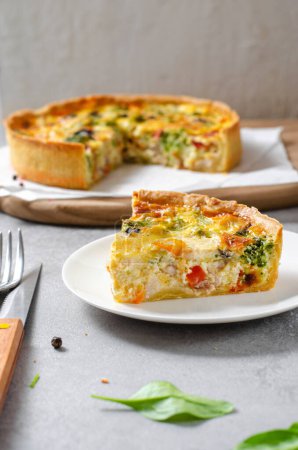 Quiche with Vegetables and Chicken, Homemade Open Pie, Savory Tart on Bright Background
