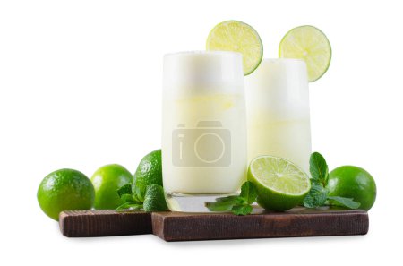 Brazilian Lemonade, Refreshing Creamy Lemonade or Limeade with Lime Slices and Mint on White Background Isolated
