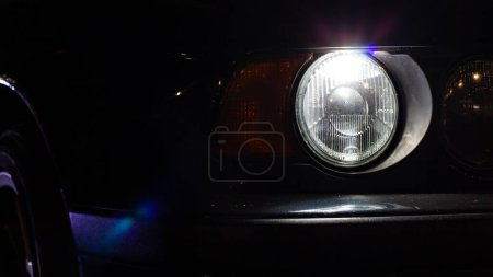 Photo for Front headlight of an old European car in the evening city - Royalty Free Image