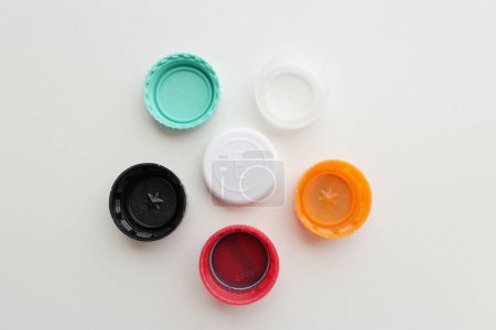 Photo for Top view of of six color plastic bottle caps on grey background - Royalty Free Image