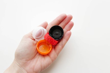 Photo for Human hand holding plastic bottle caps - Royalty Free Image