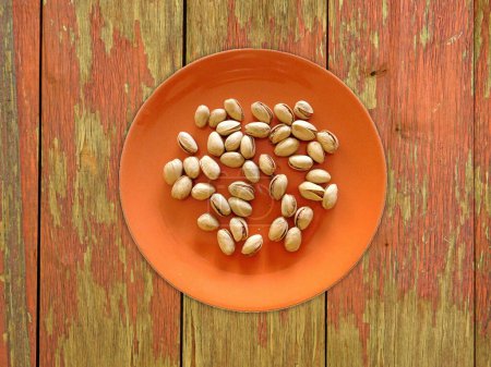 Photo for Pistachios On The Wooden Background - Royalty Free Image