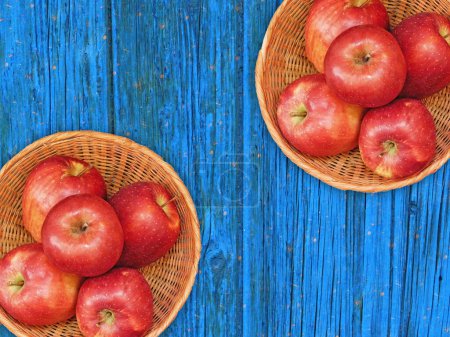Photo for Top view of Fresh Ripe Apples in Wicker Baskets On Wooden Background - Royalty Free Image