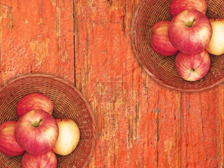 Photo for Top view of Fresh Ripe Apples in Wicker Baskets On Wooden Background - Royalty Free Image
