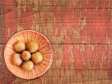 Photo for Close-up shot of ripe kiwi fruits on Wooden Background - Royalty Free Image