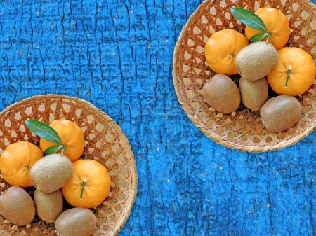 Photo for Kiwi and oranges on the wooden background - Royalty Free Image