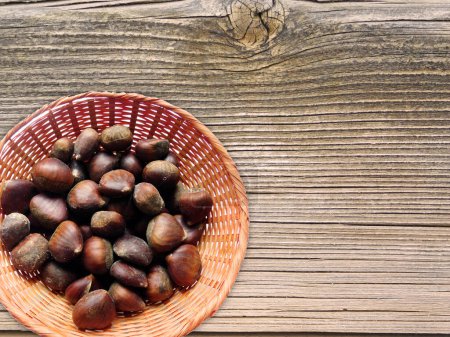 Photo for Chestnuts On Wooden Background, top view - Royalty Free Image