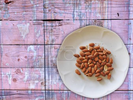 Photo for Almonds on wooden background - Royalty Free Image