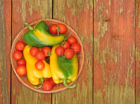 Photo for Bell peppers with cherry tomatoes on wooden background - Royalty Free Image