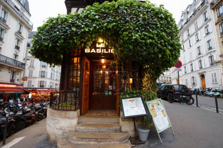 Téléchargez les photos : Paris, France-29 avril 2023 : Le restaurant traditionnel français Le Basilic situé dans le pittoresque quartier de Montmartre à Paris. - en image libre de droit