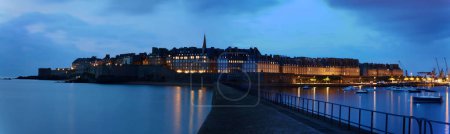 Photo for Panoramic night view of walled city Saint-Malo with St Vincent Cathedral, famous port city of Privateers is known as city corsair, Brittany, France . - Royalty Free Image