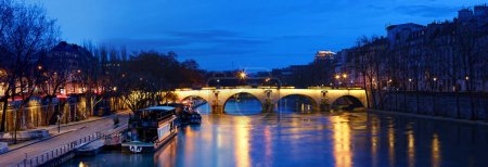 The panoramic view of bridge Ponte Marie over Seine river at night , Paris, France. It is one of the oldest bridges in Paris that dates back to the 17th century.