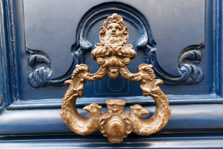 European Vintage old metal wrought iron door knocker. Design detail. Paris.France