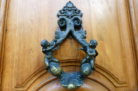 European Vintage old metal wrought iron door knocker. Design detail. Paris.France