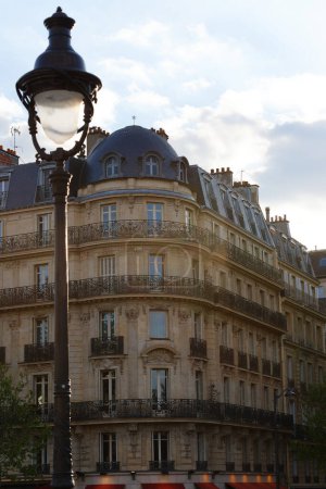 The facade of traditional French house with typical balconies and windows. Paris, France.