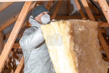 Photo for Insulation of the roof and ceiling with glass wool. - Royalty Free Image