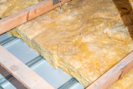 Foto de Glass wool for ceiling insulation on the roof. - Imagen libre de derechos