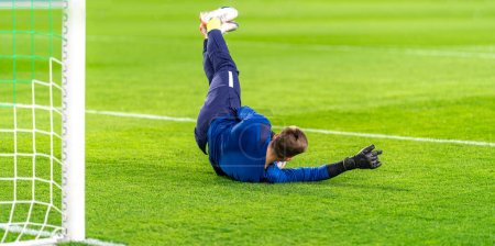 goalkeeper catches the ball in the goal in a soccer match. High quality photo