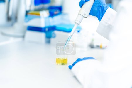 Photo for Pipetting a chemical sample into research flasks. High quality photo - Royalty Free Image