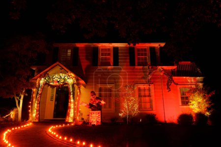 Photo for House decorated for Halloween with Large Jack in a Box and Orange Lights - Royalty Free Image