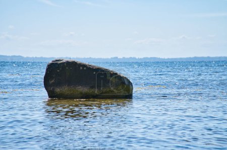 Photo for Single stone, rock in the Baltic Sea in sunshine. Landscape photo from the coast. - Royalty Free Image