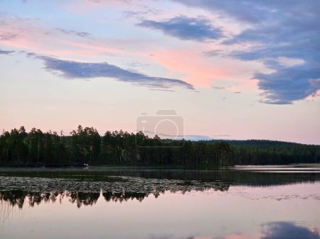 Photo for Sunset on a lake in Sweden. Blue hour on calm water. Nature photo from Scandinavia. Landscape shot - Royalty Free Image