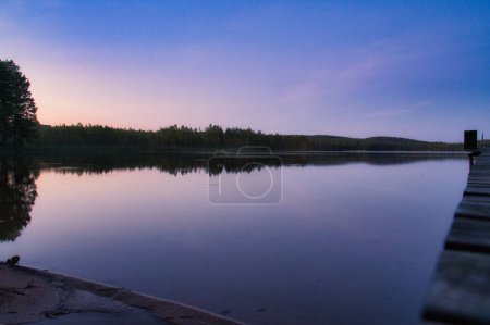 Photo for Sunset on a lake in Sweden. Blue hour on calm water. Nature photo from Scandinavia. Landscape shot - Royalty Free Image